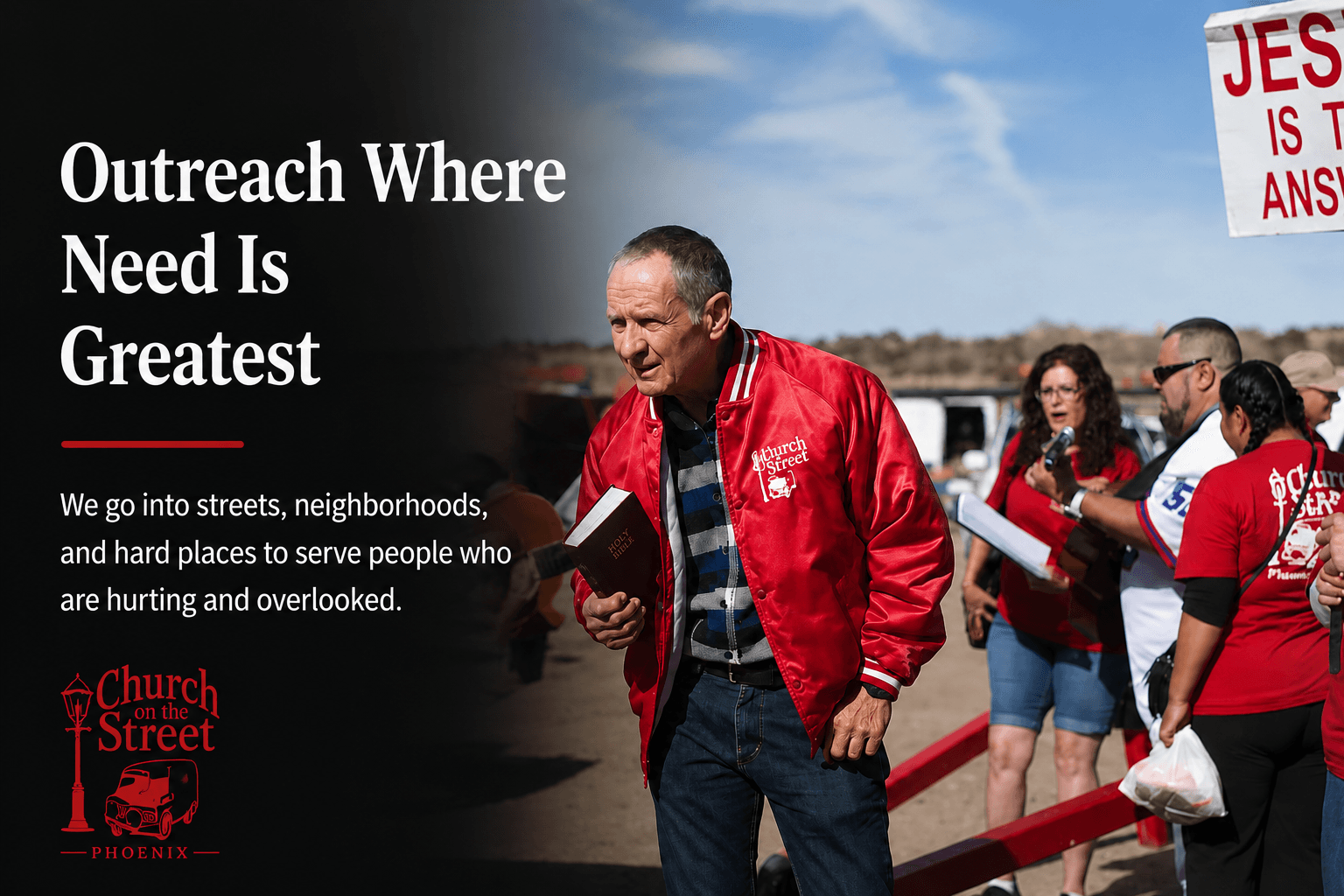 Man in red jacket holding a Bible at an outdoor Church on the Street outreach.